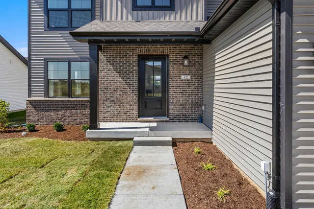 a view of a brick house with many windows