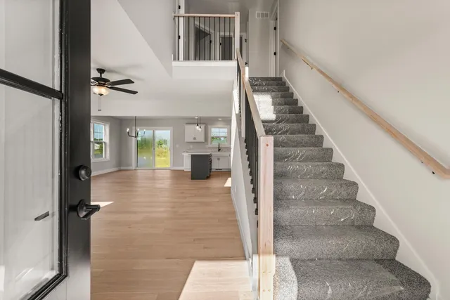 a view of an entryway with wooden floor and staircase