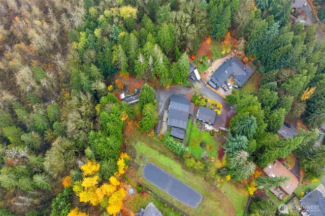 an aerial view of a house with a yard and lake view