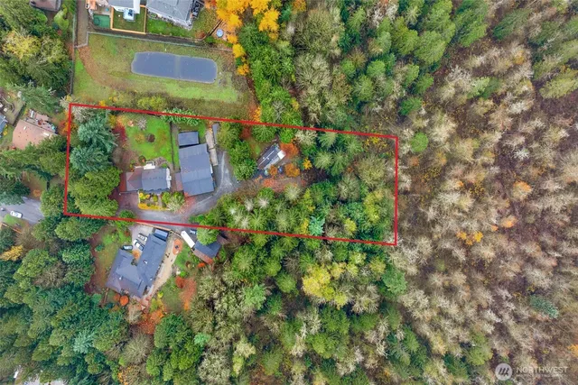 an aerial view of multiple houses with yard