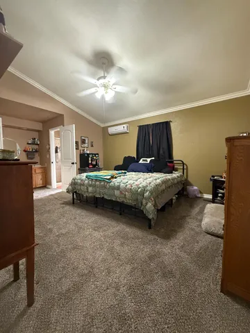 a bedroom with a bed and dresser