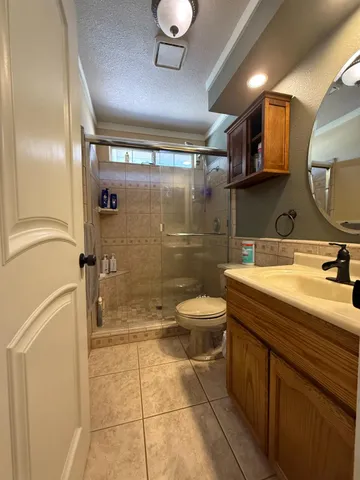 a bathroom with a toilet and a shower