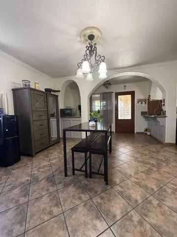 a living room with furniture and a chandelier