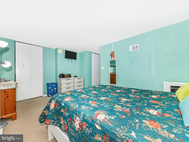 a bedroom with a bed and a dresser