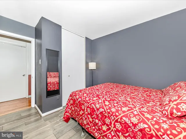 a bedroom with a bed and a desk