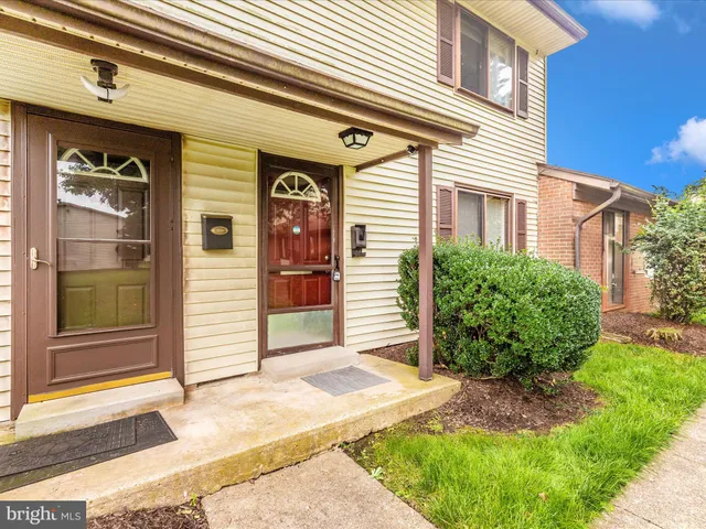 a view of a house with garden and a trees