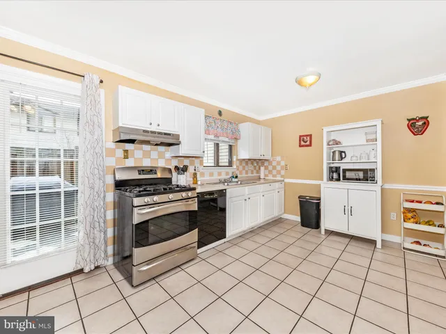 a kitchen with stainless steel appliances a refrigerator sink and stove
