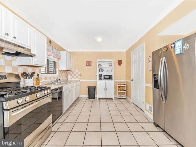 a kitchen with stainless steel appliances a refrigerator and a stove