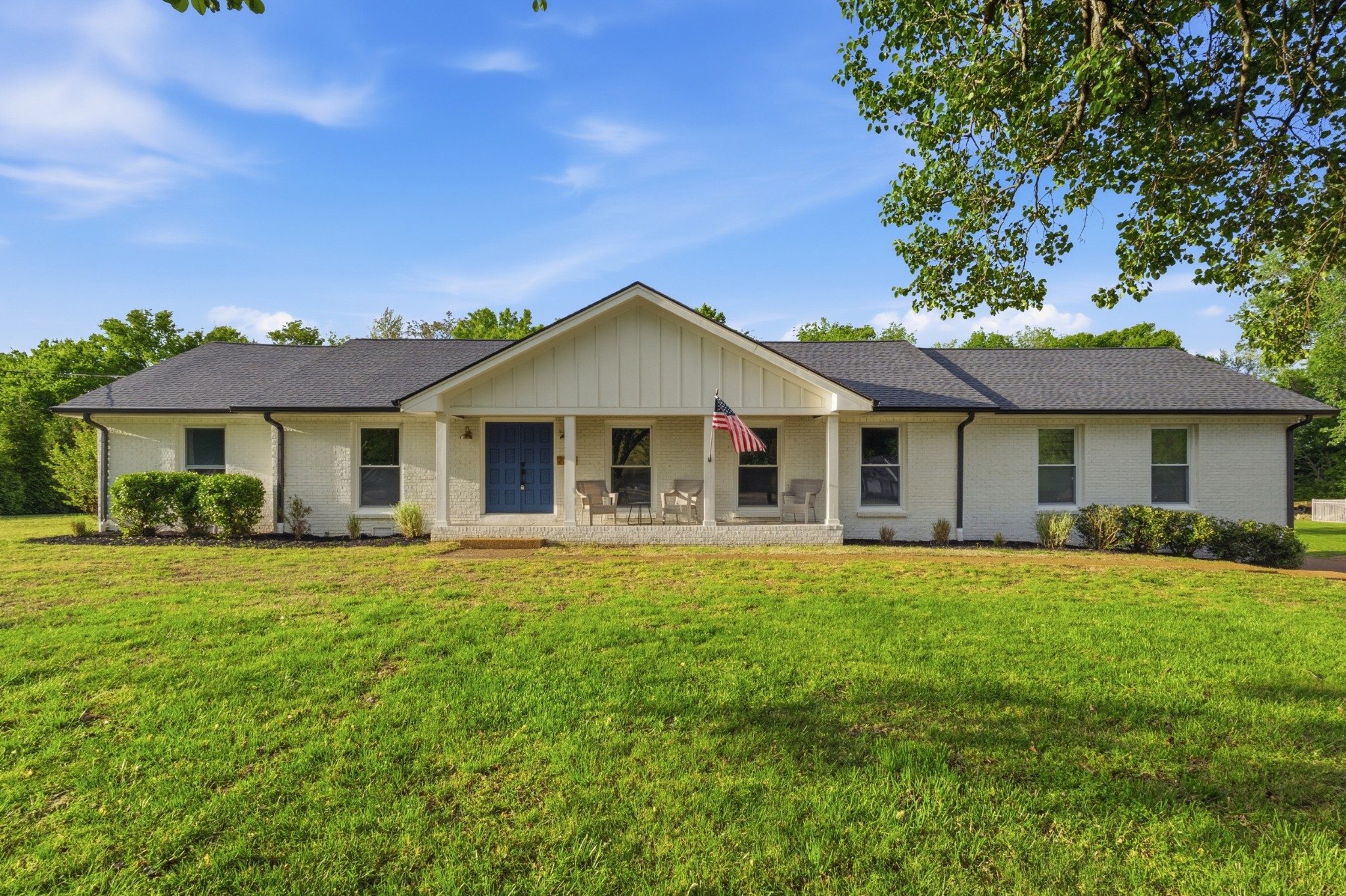 a front view of a house with a garden