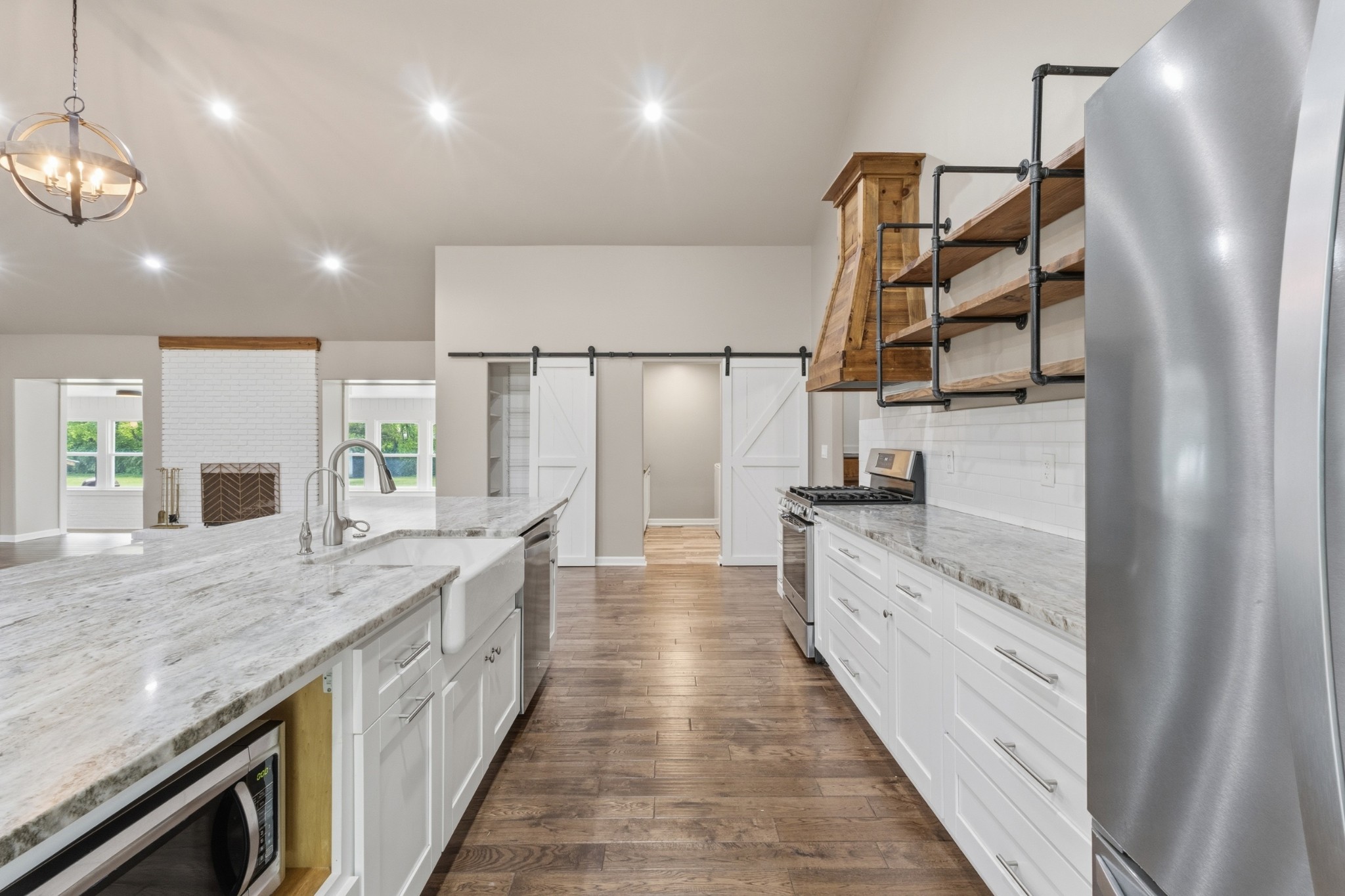 2228 Bowman Road Franklin, TN 37064 - Photo 11 of 44 a large white kitchen with a large counter top space a sink stainless steel appliances and cabinets