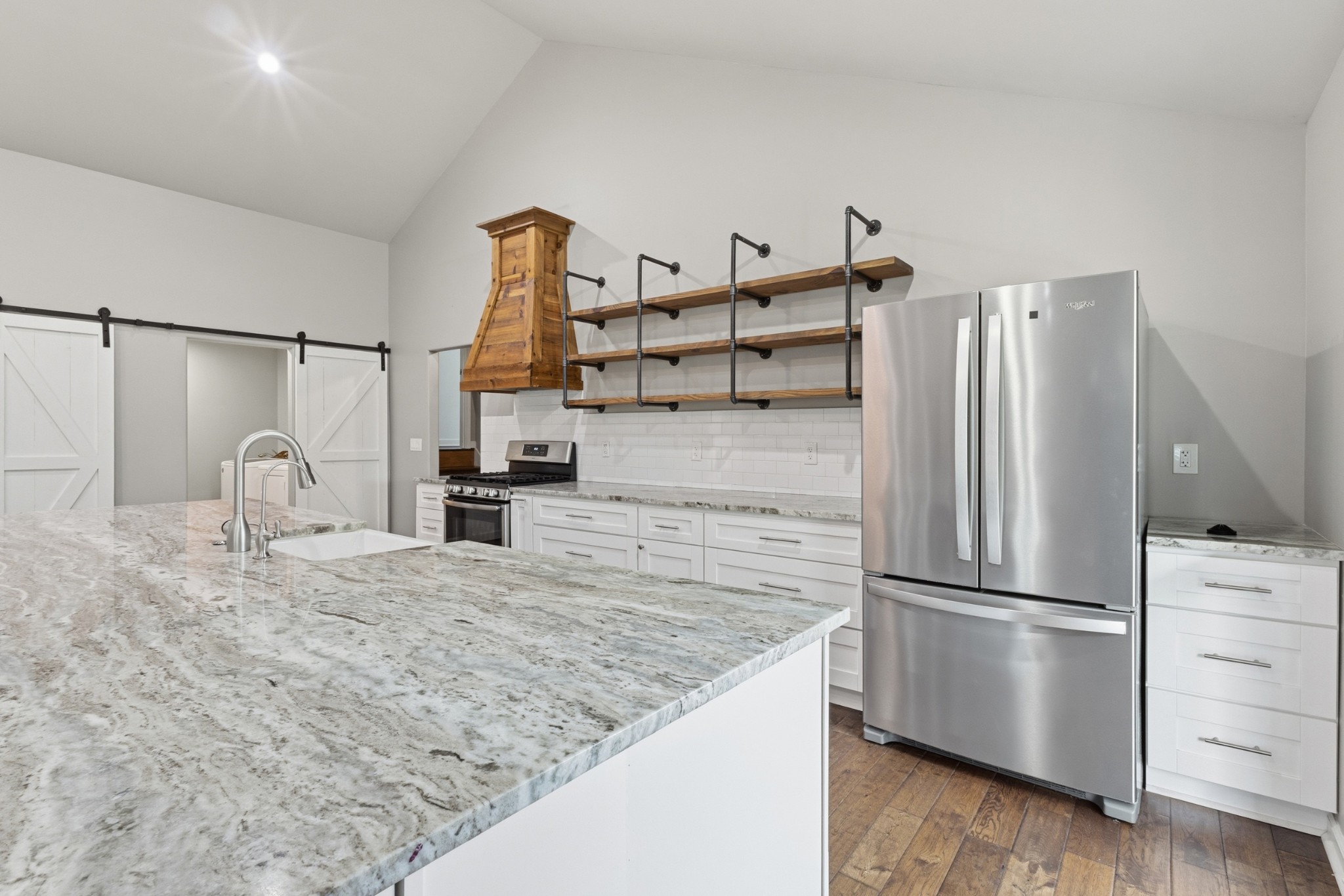2228 Bowman Road Franklin, TN 37064 - Photo 12 of 44 a kitchen with granite countertop a refrigerator and a stove top oven
