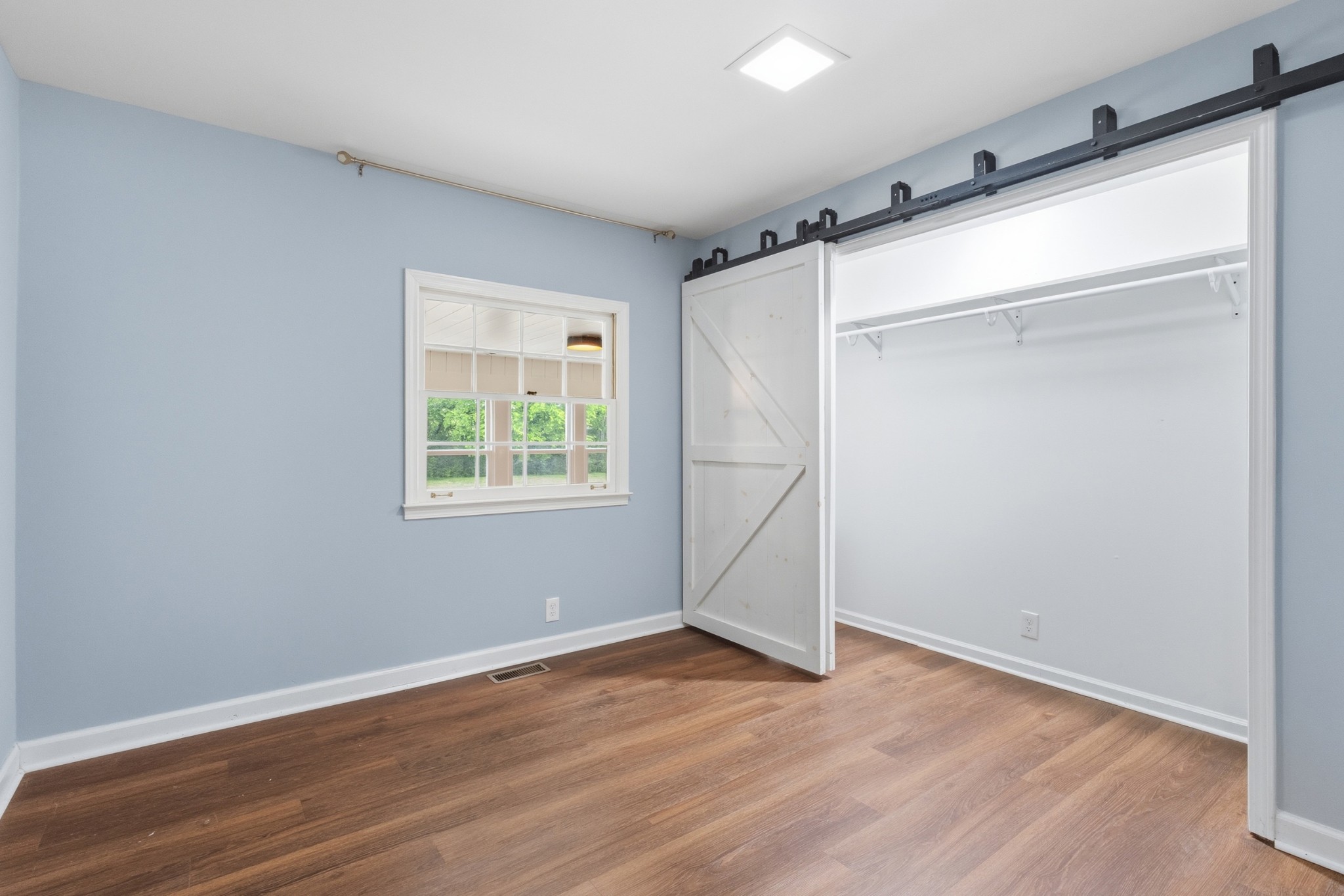 2228 Bowman Road Franklin, TN 37064 - Photo 25 of 44 a view of an empty room with wooden floor and a window