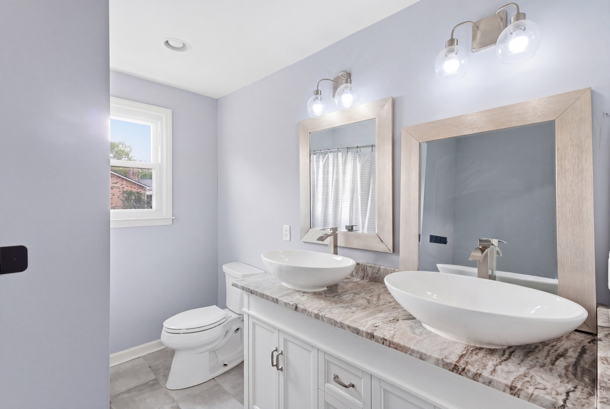2228 Bowman Road Franklin, TN 37064 - Photo 29 of 44 a bathroom with a granite countertop sink a toilet and a mirror