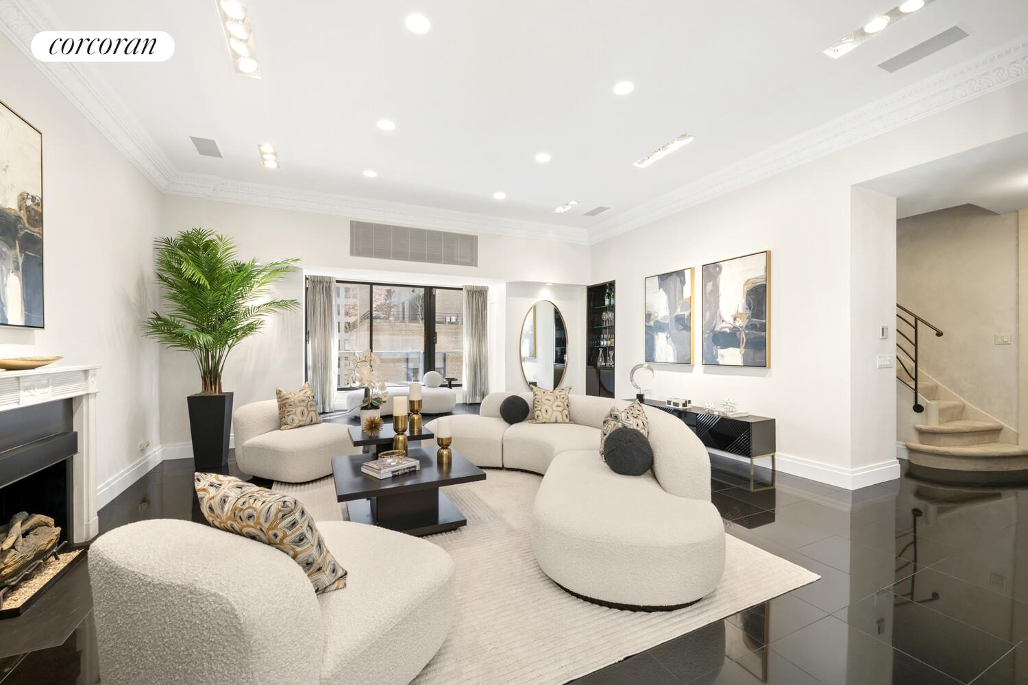 880 5th Avenue, Unit 12L Manhattan, NY 10021 - Photo 1 of 12 a living room with furniture and a large window