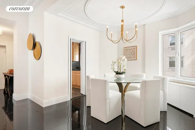 a view of dining table chairs and window