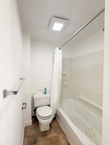 a bathroom with a toilet a sink and bathtub
