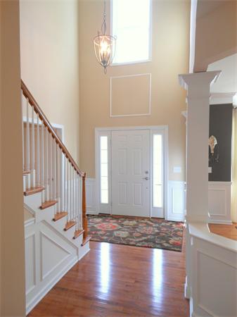 a view of an entryway with wooden floor and staircase