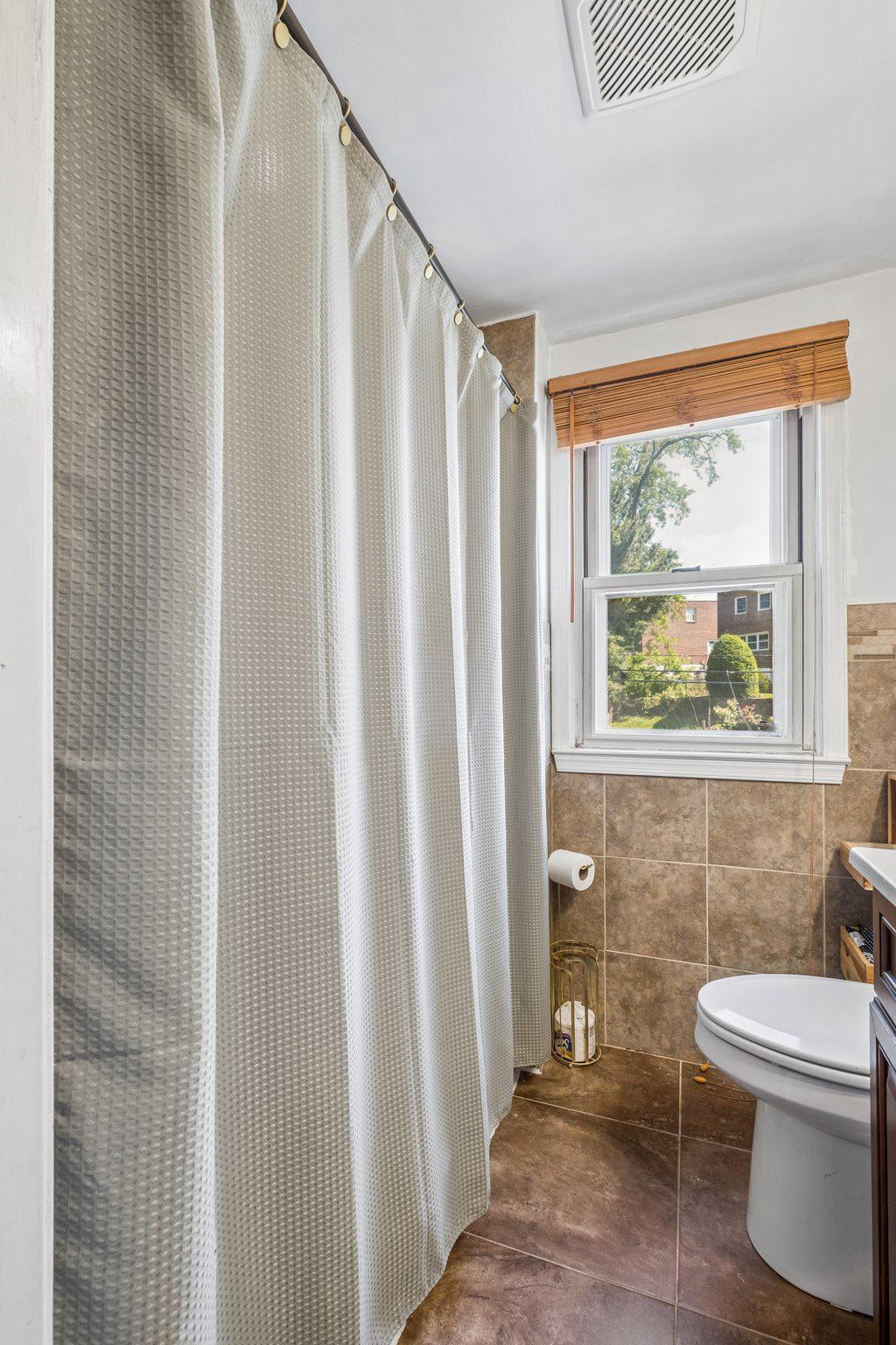 725 Hill Road Philadelphia, PA 19128 - Photo 21 of 43 a bathroom with a toilet a sink and a window