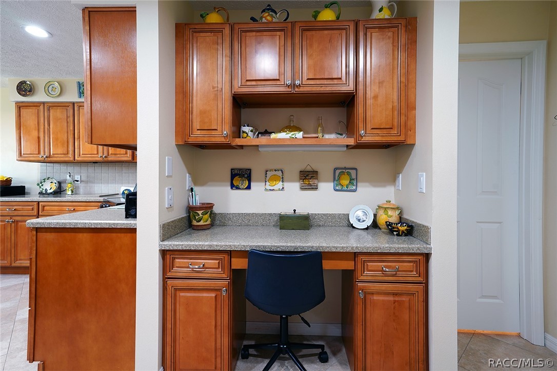 800 Balmoral Court Inverness, FL 34453 - Photo 20 of 72 a kitchen with stainless steel appliances granite countertop a sink a stove a chimney a refrigerator and cabinets
