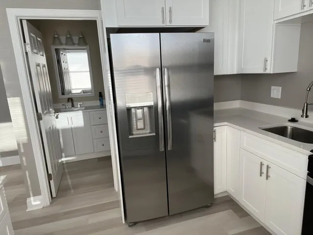 a kitchen with metallic refrigerator freezer and a sink