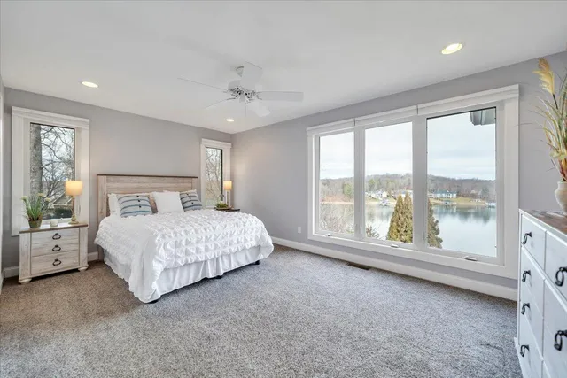 a view of a house with a yard from a lake view