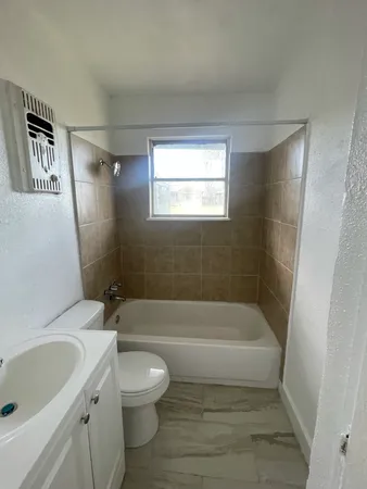 a bathroom with a sink a toilet and bathtub