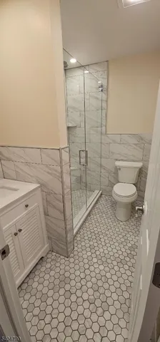 a bathroom with a toilet and a shower