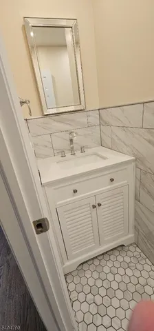 a bathroom with a sink a vanity and a mirror