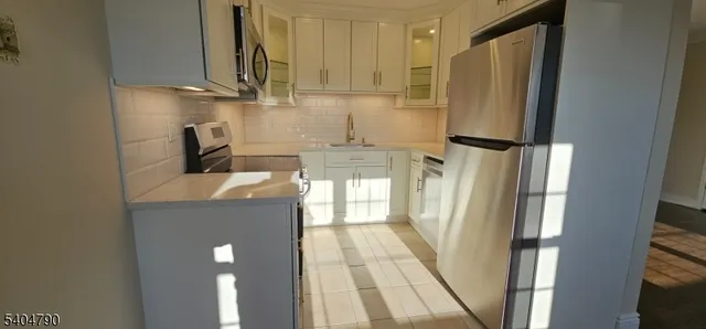 a kitchen with a refrigerator and a stove