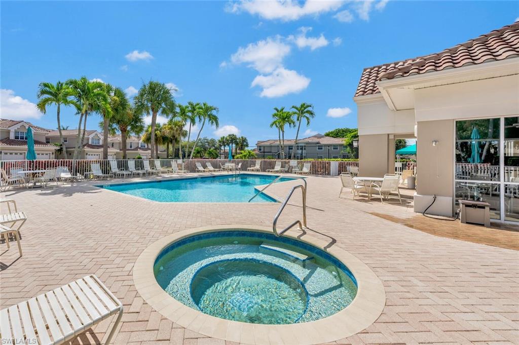 3520 Windjammer Circle, Unit 102 Naples, FL 34112 - Photo 22 of 26 a swimming pool with outdoor seating and yard