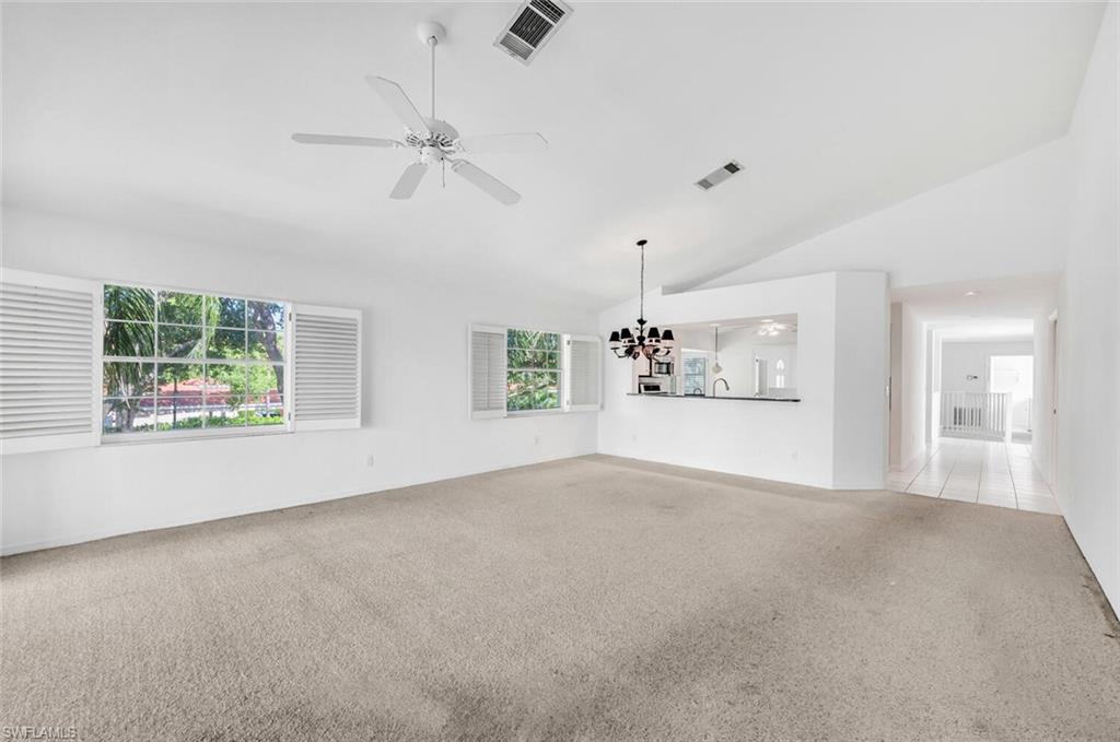 3520 Windjammer Circle, Unit 102 Naples, FL 34112 - Photo 8 of 26 an empty room with windows and fireplace