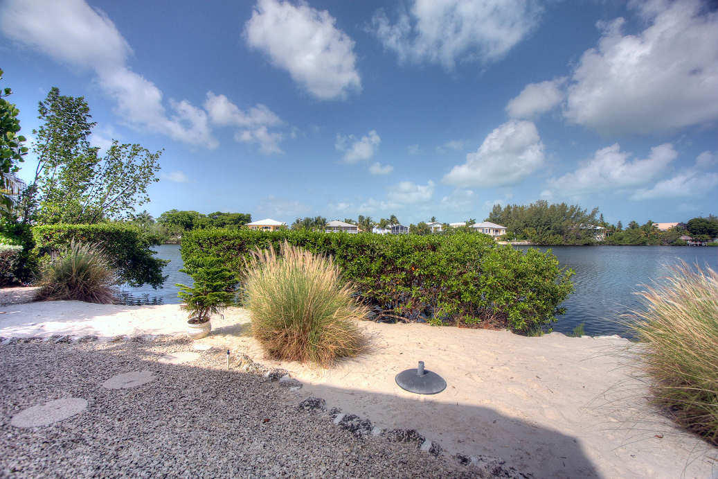 42 Mutiny Place Key Largo, FL 33037 - Photo 35 of 40 Sandy beach area off back yard to lake
