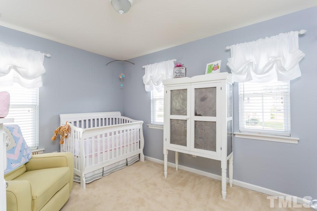 2629 Quarry Ridge Lane Raleigh, NC 27610 - Photo 11 of 12 a bedroom with windows and a bed