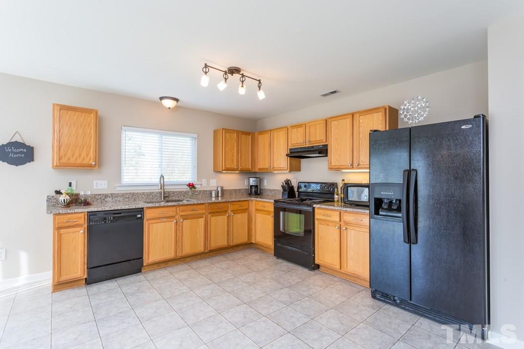 2629 Quarry Ridge Lane Raleigh, NC 27610 - Photo 4 of 12 a large kitchen with cabinets and stainless steel appliances