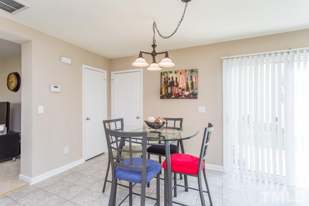 2629 Quarry Ridge Lane Raleigh, NC 27610 - Photo 6 of 12 a view of a dining room with furniture and chandelier