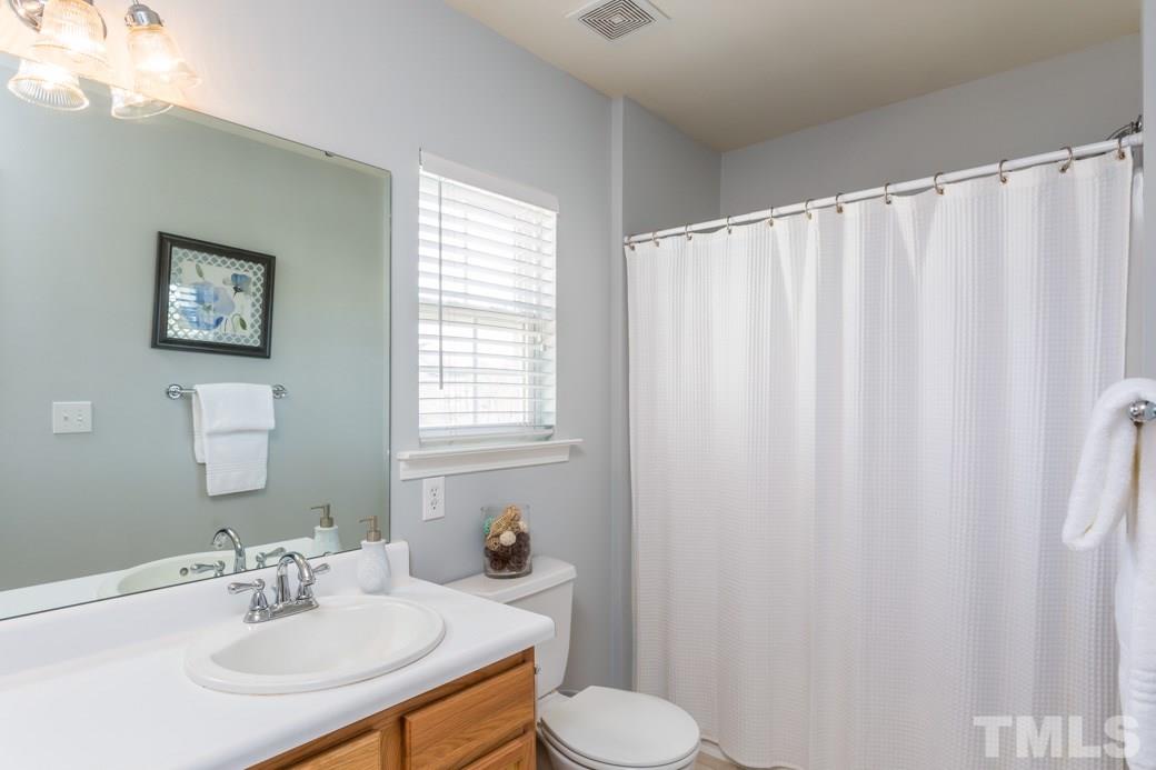2629 Quarry Ridge Lane Raleigh, NC 27610 - Photo 7 of 12 a bathroom with a sink and a mirror