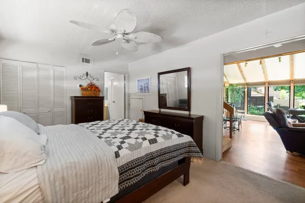 a bedroom with a large bed and a chandelier
