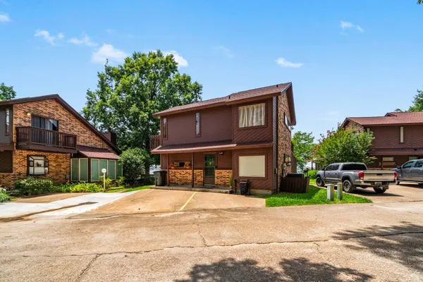 a front view of a house with a garden and plants