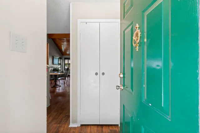 an entryway with wooden floor and closet