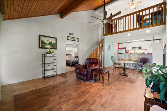 a living room with furniture and a potted plant