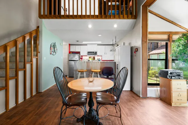 a dining room with furniture and wooden floor