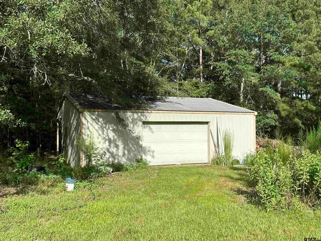 a view of a house with a yard and garage