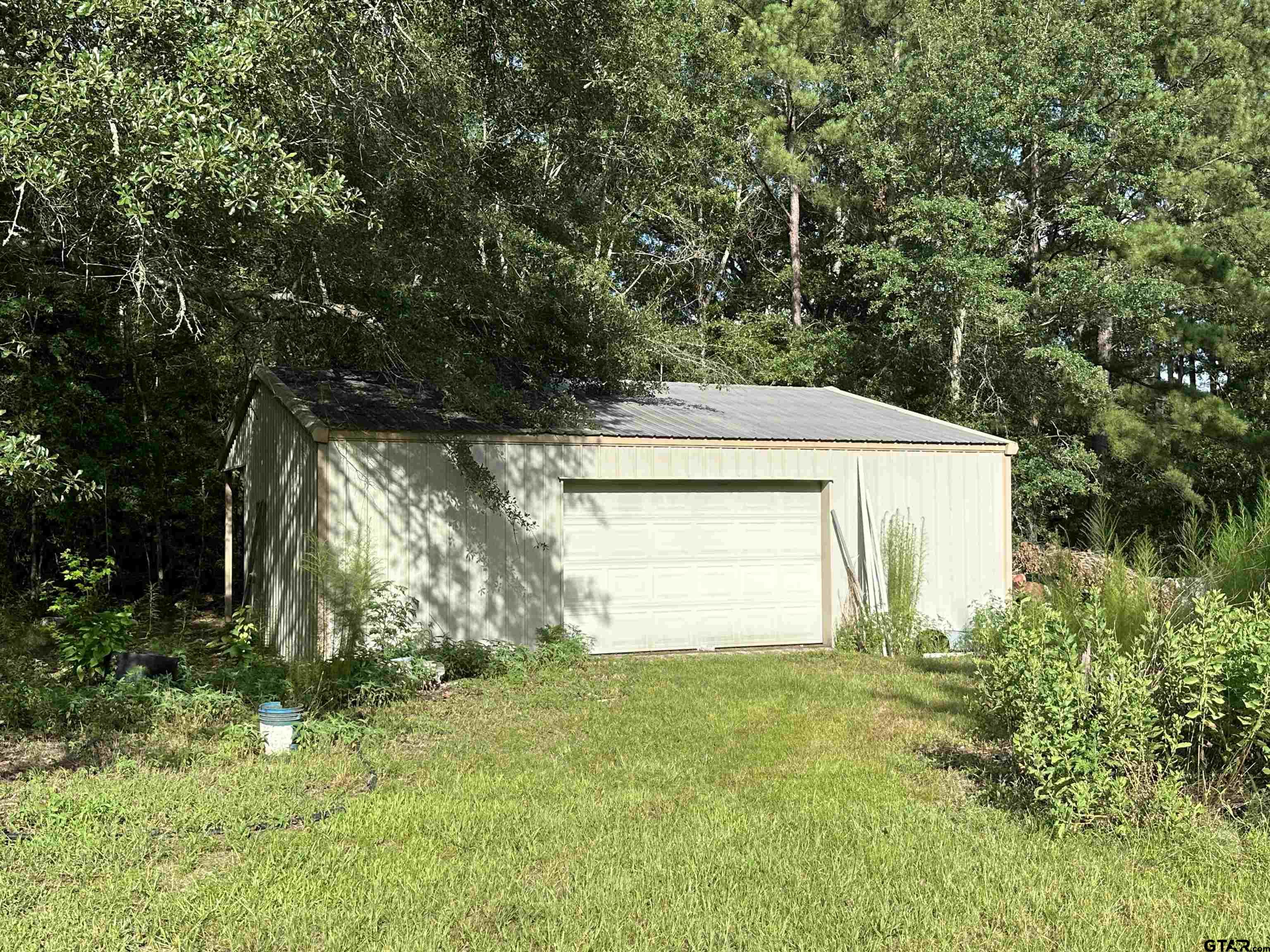 a view of a house with a yard and garage