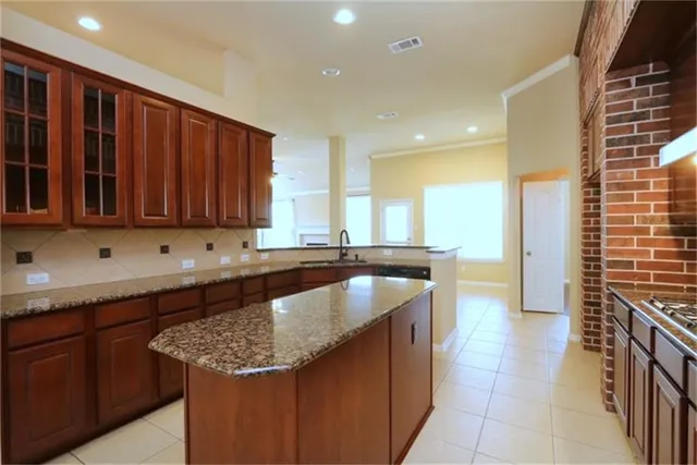 a kitchen with granite countertop sink vanity and cabinets