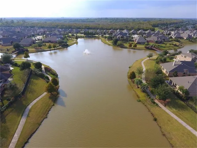 an aerial view of a houses with ocean view