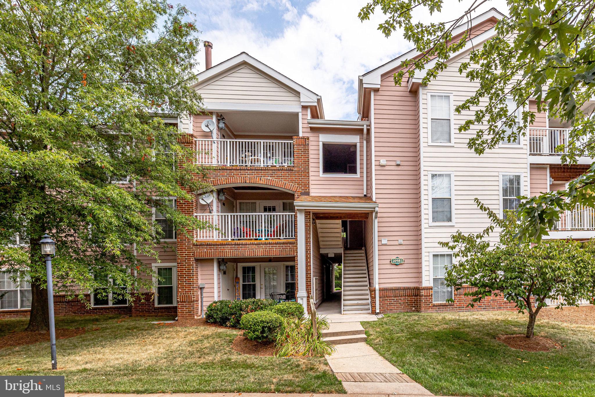 20985 Timber Ridge Terrace, Unit 104 Ashburn, VA 20147 - Photo 3 of 43 Or enter the condo from the left of the building