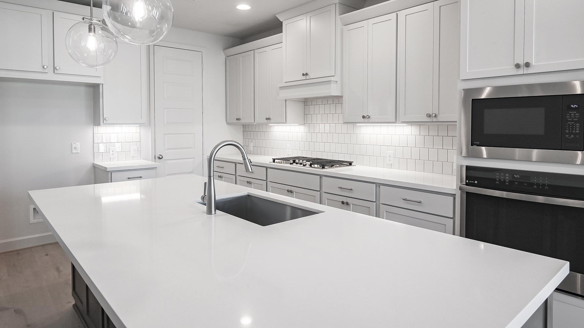 523 Prickly Poppy Loop Kyle, TX 78640 - Photo 8 of 40 a kitchen with kitchen island a sink stainless steel appliances and cabinets