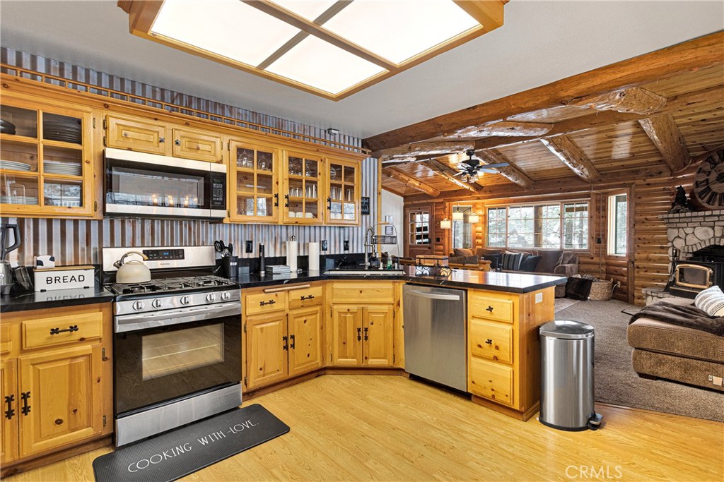 42363 Paramount Road Big Bear Lake, CA 92315 - Photo 15 of 58 a kitchen with stainless steel appliances granite countertop a stove and cabinets