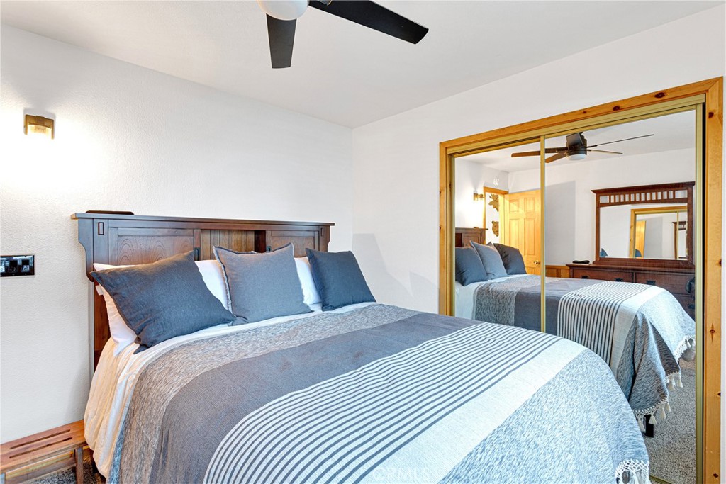 42363 Paramount Road Big Bear Lake, CA 92315 - Photo 21 of 58 a bed room with a bed and a large mirror