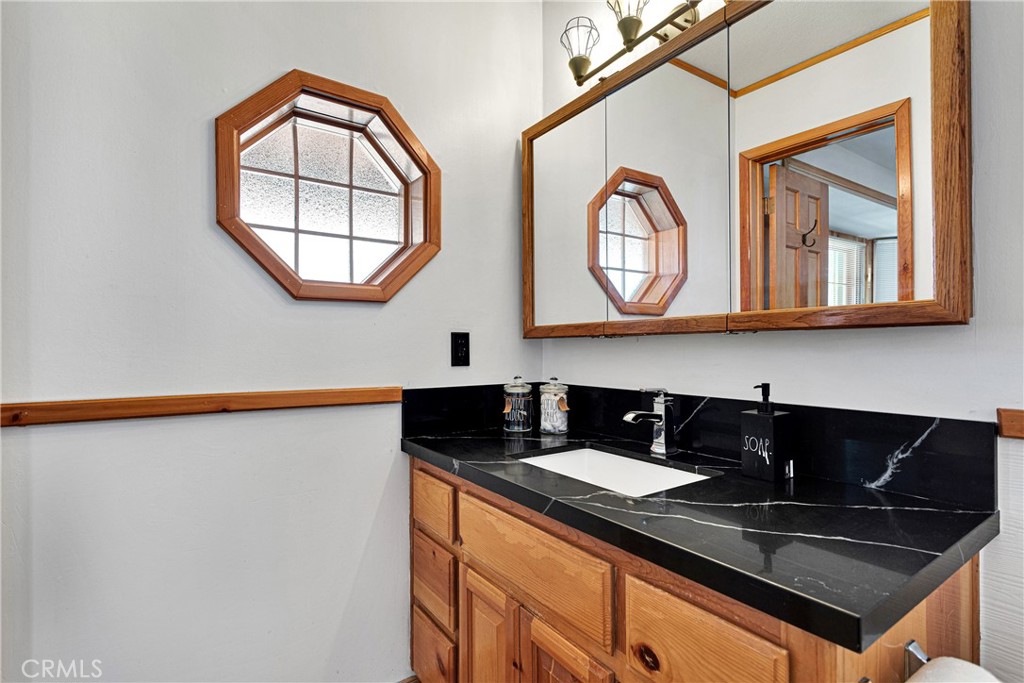 42363 Paramount Road Big Bear Lake, CA 92315 - Photo 26 of 58 a kitchen with stainless steel appliances granite countertop a stove a sink and a microwave